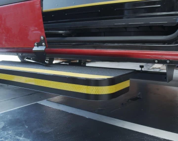 Level view of the UpStep retracted underneath the side of a van, showing off the mounting apparatus.